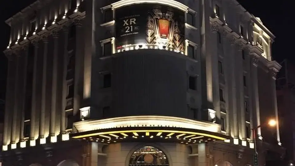 夜色中亮起暖色燈光的海派酒店建築外觀